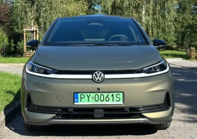 Volkswagen ID.3 Neo stoi na brukowanej drodze – widać przód auta, w tle są drzewa.